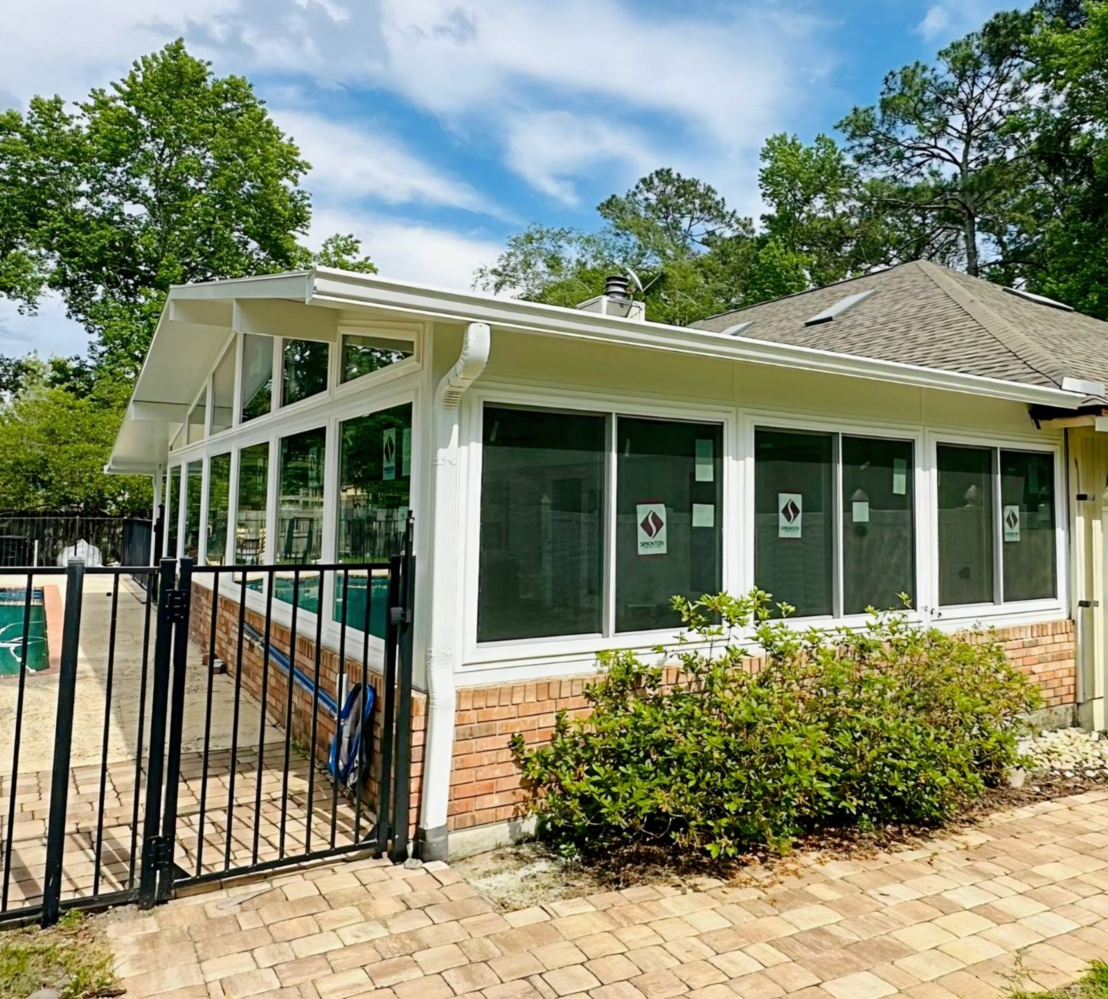 Gable sunroom with a brick kneewall and tall windows with transoms, built by Better Home Improvement in Jacksonville, FL